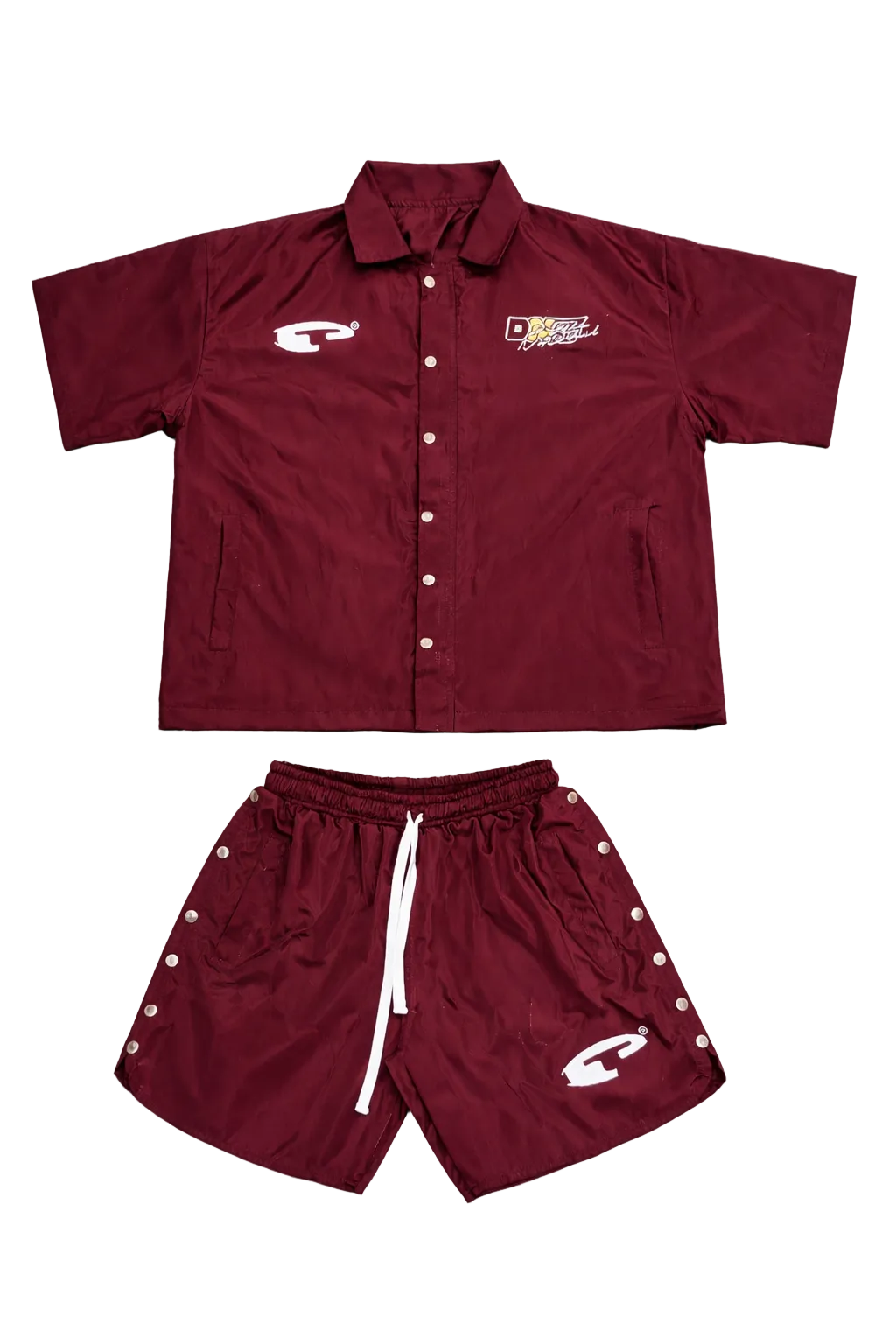 Maroon shirt and shorts set with logos on a gray surface